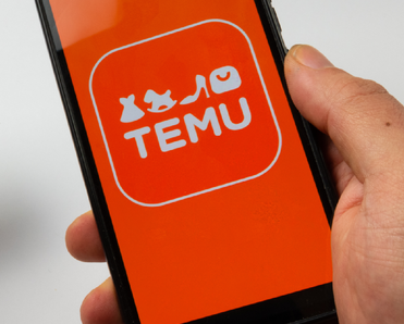 Someone using a credit card to make a purchase on the Temu mobile app