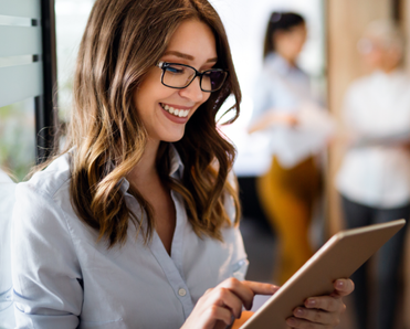 A woman uses a tablet in an office. 