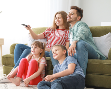 A family watches TV together.