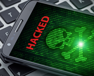 skull of death on smartphone screen. Hacked mobile phone on laptop computer