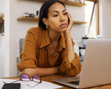 Woman looking sad at laptop