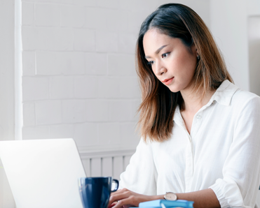 A woman types on her computer. 