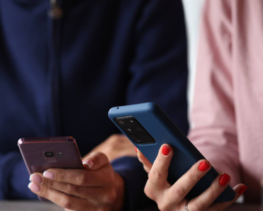 Two Android users holding their phones