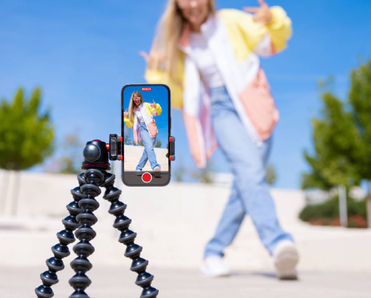 Teenage girl filming TikTok video of herself on mobile phone