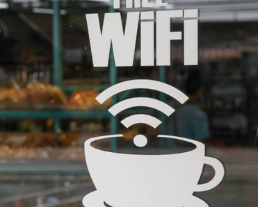 White decal &quot;Free Wi-Fi&quot; sign in coffee shop window