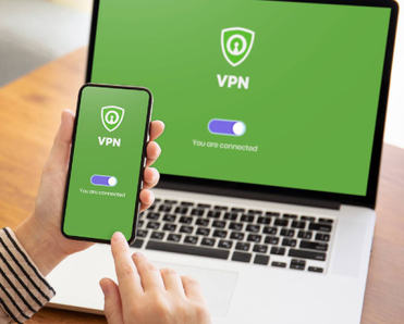 A woman using a vpn on a mobile device and laptop
