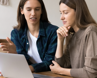 Two people at a laptop
