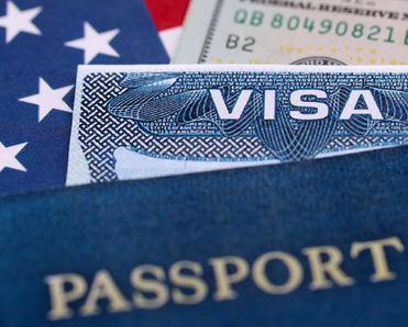 A picture of a visa and passport overtop American flag and dollar bill