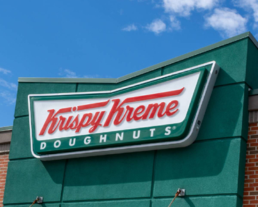 Close up of a Krispy Kreme sign on building