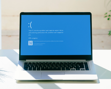 Laptop screen with Microsoft's Blue Screen of Death.