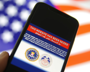 Phone screen showing a website has been seized by the FBI.