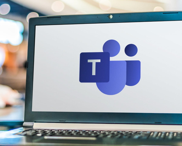 Laptop computer displaying logo of Microsoft Teams.