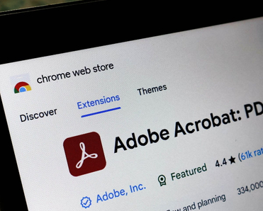 Laptop screen displaying the Adobe Acrobat extension page on the Chrome web store.