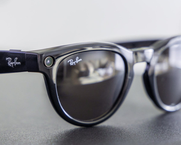 Close-up of black Meta Ray-Ban smart glasses featuring a camera lens.
