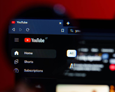 A closeup of a magnifying glass on YouTube desktop
