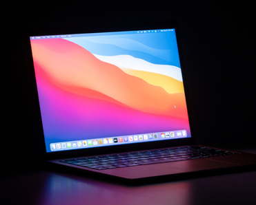 MacBook Air isolated on a desk in the dark.