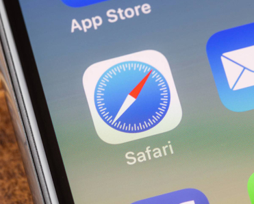 Close up to safari app on the screen of an iPhone X with personalized background