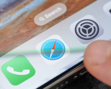 Closeup of person tapping Safari icon on smartphone