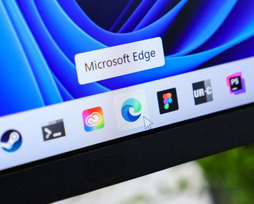 Microsoft Edge browser icon with cursor hovering on taskbar of a modern Windows 11 operating system display, illustrating digital web navigation experience