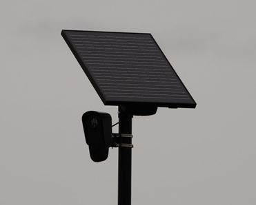 Flock safety police law enforcement license plate reader set up outside.