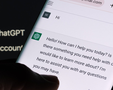ChatGPT chat bot screen seen on smartphone and laptop display with Chat GPT login screen on the background.