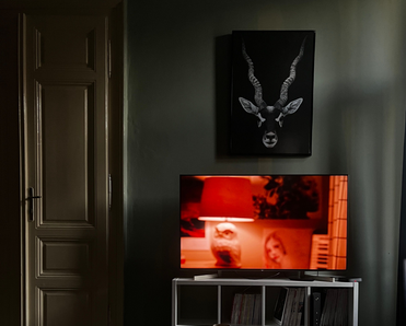A TV with a red image on the screen, sitting in a dark room.