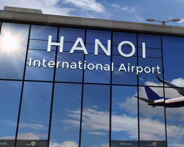Hanoi International Airport sign on side of building.