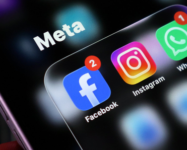 Closeup of a smartphone screen displaying the meta app group folder containing facebook, instagram, and whatsapp icons with notification badges.