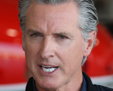 Governor Gavin Newsom speaking at a conference.