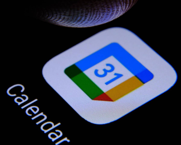 Google calendar app and blurred finger tip above it ready to press the screen of smartphone.