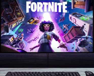 Gaming setup displaying Fortnite artwork on widescreen monitor