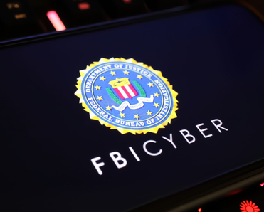 Smartphone screen with logo lettering of FBI Cyber.