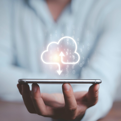 A man balances his cell phone on his fingertips while a download icon (a cloud outline with an arrow pointing down toward the phone) floats above it