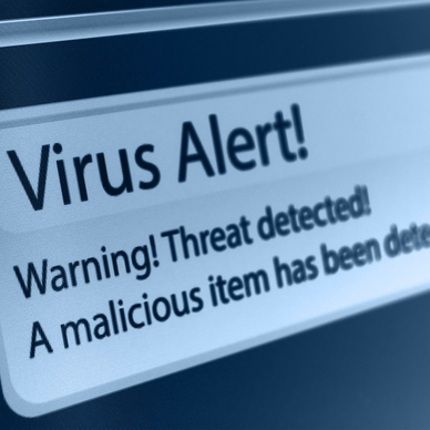 A close-up of a computer screen showing a virus alert that says a threat and malicious item has been detected