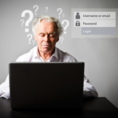 An older man sits at a laptop trying to remember his username and password