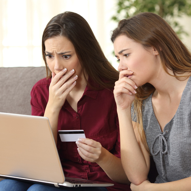 Women looking at computer nervously
