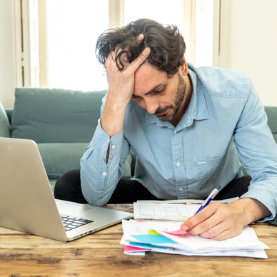 Stressed man looking at mail