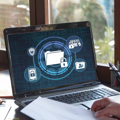 A laptop screen is showing confidential data that is being locked.