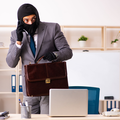 man in a suit and a black mask acting suspicious