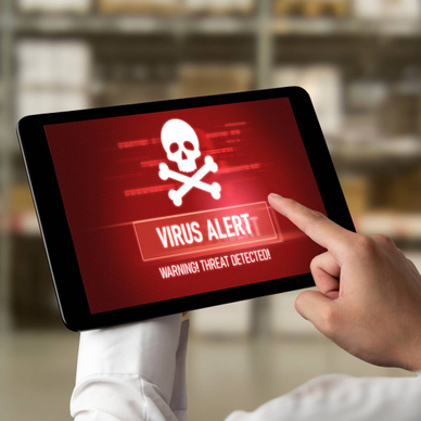 A tablet user is pointing at the virus alert on their tablet.