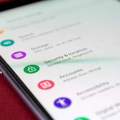 A close-up of an Android phone with a focus on the Security &amp; Location settings button.