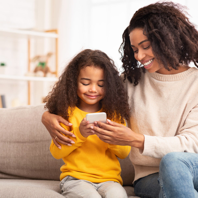 mother and her daughter using an iPhone with parental controls