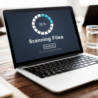 Open laptop with 25% scanning files on the screen