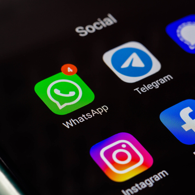 The WhatsApp and Telegram apps on an iPhone screen.