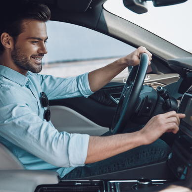 Man driving car pressing screen on the car panel