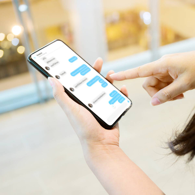 Woman using her mobile smartphone. She&#x27;s chatting with friend on mobile phone