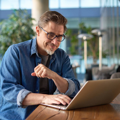 Man at computer in his living room/