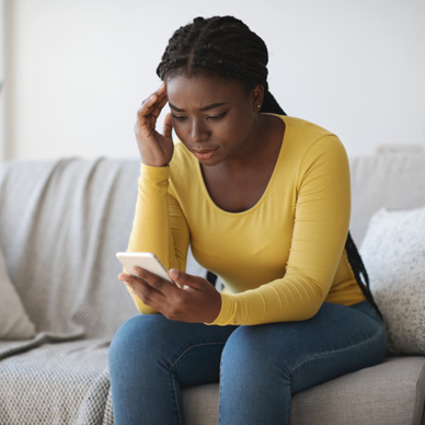 Woman looking concerned at her phone