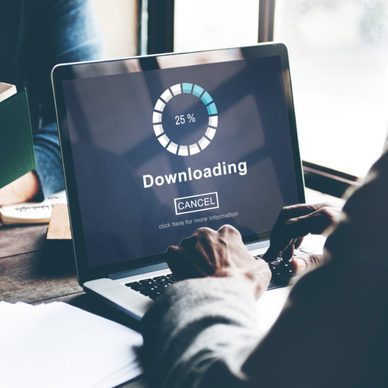 Man on laptop downloading a file