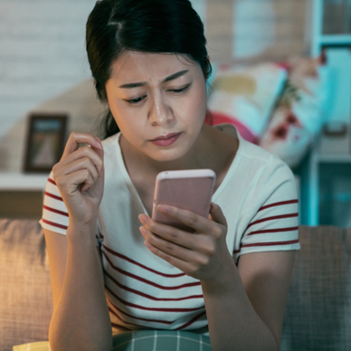 Woman looking skeptically at her phone
